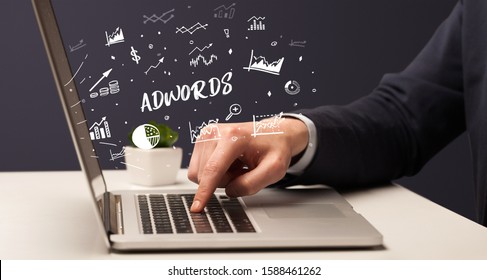 Businessman working on laptop with ADWORDS inscription, modern business concept