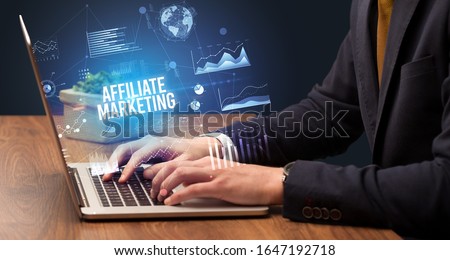 Businessman working on laptop with AFFILIATE MARKETING inscription, new business concept