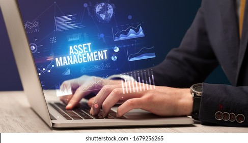 Businessman Working On Laptop With ASSET MANAGEMENT Inscription, New Business Concept