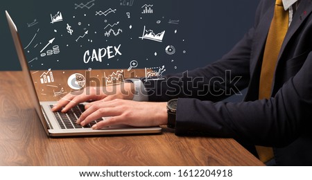 Businessman working on laptop with CAPEX inscription, modern business concept