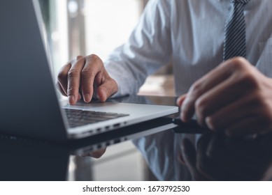 Businessman working on laptop computer with digital tablet and mobile smart phone on desk. Business man connecting internet, networking in modern office, closeup
