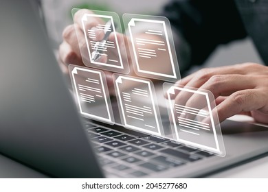 Businessman working on laptop computer with electronics document icons, E-document management, online documentation database, paperless office concept