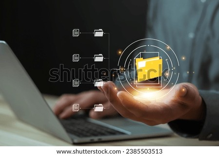 Businessman working on a laptop computer document, manage, file,  data, folder,  share, digital, information,  Electronic document management online document database paperless office concept 
