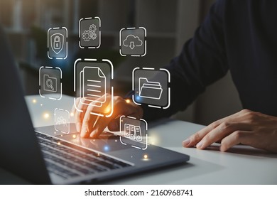 Businessman Working On Laptop With Document Management Icon, Online Document File Management, Database Technology Concept.