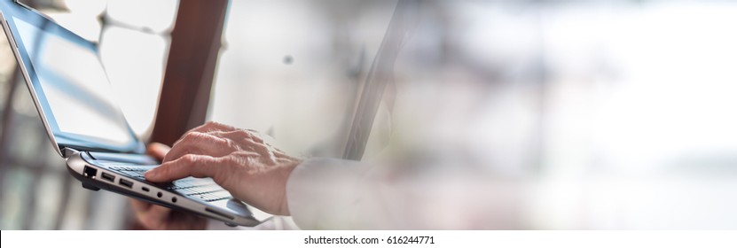 Businessman Working On Laptop In Office