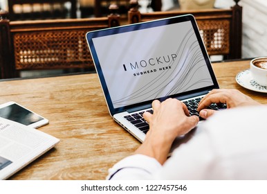 Businessman working on a laptop screen mockup
