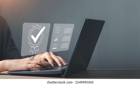 Businessman working on laptop with sign of Quality assurance, Guarantee, ISO certification and standardization. Compliance to regulations and standards, International information security standard. - Shutterstock ID 2149495343