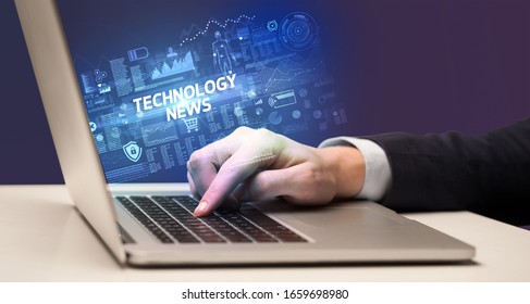 Businessman working on laptop with TECHNOLOGY NEWS inscription, cyber technology concept - Shutterstock ID 1659698980