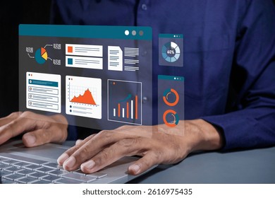 A businessman working on laptop with a virtual screen of financial and business data analysis graphs