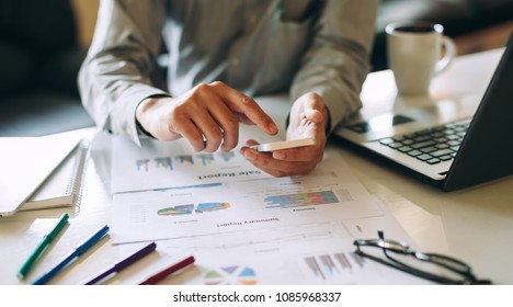 businessman working on project for analyzing company financial report balance statement with documents graphics at modern office space. Concept picture of business,economy, market,money and tax.