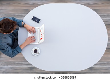 Businessman Working On White Laptop Computer At Grey Office Round Table With Coffee Mug And Telephone Top View