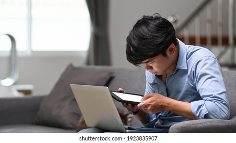 Businessman Working Online On Laptop And Using Digital Tablet At Home.