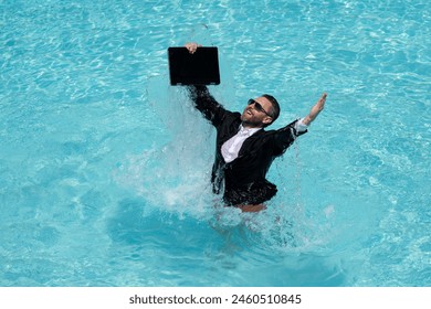 Businessman working on-line outdoor. Travel destinations, summer vacations. Funny business man in suit on summer holiday at sea beach water. Crazy entrepreneur using laptop on vacation. - Powered by Shutterstock