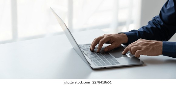 businessman working in a private room He is typing on a laptop keyboard. He uses a messenger to chat with colleagues in an online business. concept of using technology in communication. - Powered by Shutterstock