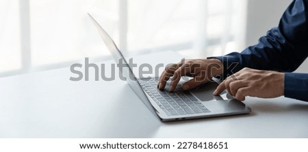 businessman working in a private room He is typing on a laptop keyboard. He uses a messenger to chat with colleagues in an online business. concept of using technology in communication.