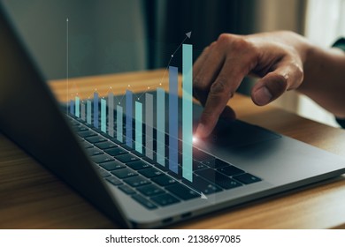 Businessman working stock traders making analysis of digital market and investment, technical chart red and green and laptop screen background for stock trading. - Shutterstock ID 2138697085