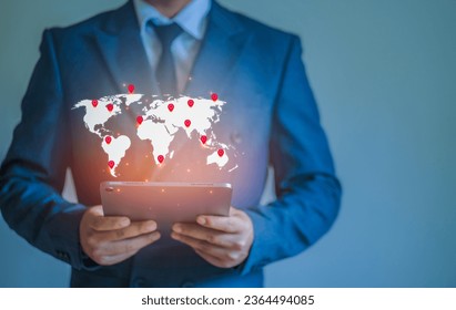 Businessman working with tablet remotely on location map pin with access to modern technology network Concept of global data access speed and enterprise expansion - Powered by Shutterstock