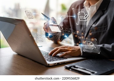 Businessman working and using a computer to manage online documentation database and digital file storage in the office, Document Management System concept - Shutterstock ID 2209536829