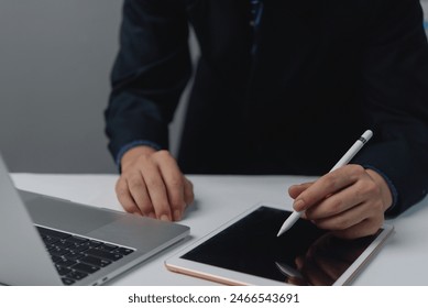 businessman working using pen on tablet to sign online. Creative technology and internet online concept - Powered by Shutterstock