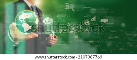 Businessman working virtual globe modern computer to reduce CO2 emissions carbon footprint climate change to limit global warming.Sustainable development and innovation green business concept.