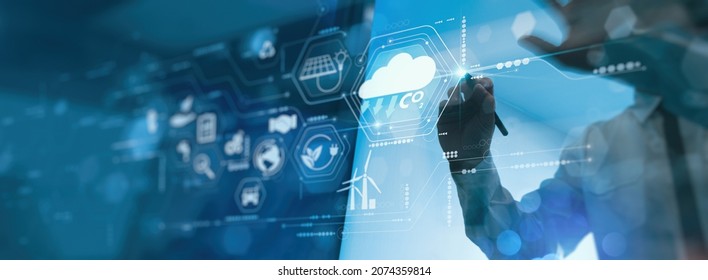 Businessman working virtual modern computer to reduce CO2 emissions carbon footprint climate change to limit global warming.Sustainable development and innovation green business concept. - Shutterstock ID 2074359814