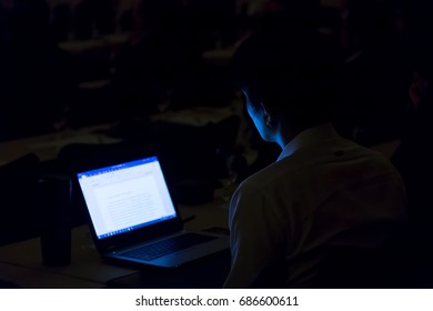 Businessman working withe modern laptop in seminar room.  business and education concept
