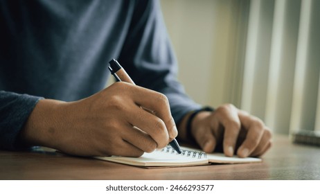 businessman working at work table,home office desk background, checklist writing planning investigate enthusiastic concept. Male hand taking notes on the notepad.  - Powered by Shutterstock