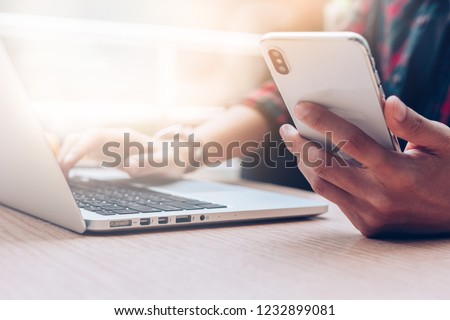 Businessman at workplace Think business investment plan.Contact Investor using cell phone,computer make note meeting of appointment information in the notebook.design creative work space