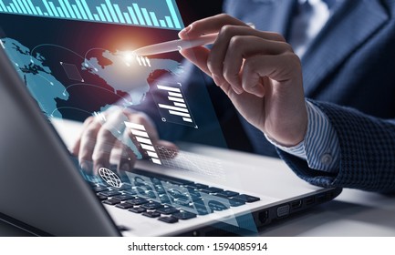 Businessman works with financial data. Futuristic 3d interface above laptop computer. Interactive financial diagrams and digital data visualization concept. Global e-business network communication