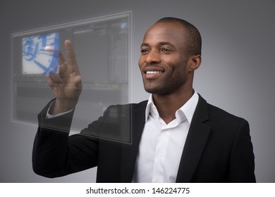 Businessman works with futuristic touch panel - Powered by Shutterstock