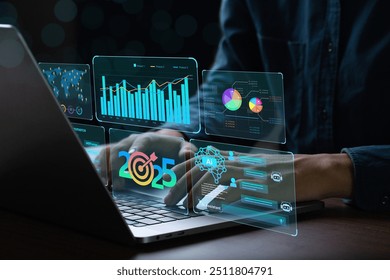 Businessman works on laptop Showing 2025 business trends dashboard with charts, metrics, AI, E-commerce, KPI. businessman planning business growth 2025. 2025 annual business plan and business strategy - Powered by Shutterstock