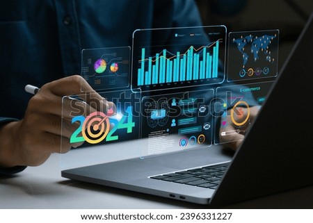 Businessman works on laptop Showing 2024 business trends dashboard with charts, metrics,  AI, E-commerce, KPI. analytical businessperson planning business growth 2024. New Year Future business tech.