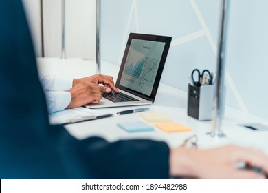 Businessman Works Using A Laptop To Analyze Financial Data .