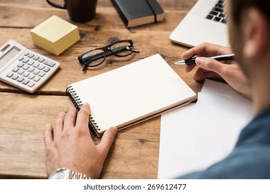 Businessman writing drawing note in blank notebook 
