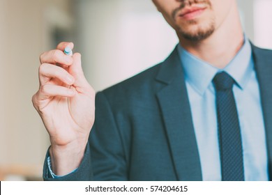 Businessman Writing on Glass Board with Marker - Powered by Shutterstock