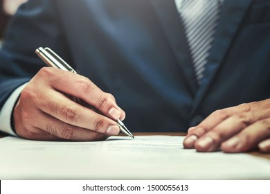 businessman writing on paper report in office concept