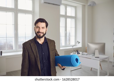 Businessman With Yoga Mat Is Standing In Office.