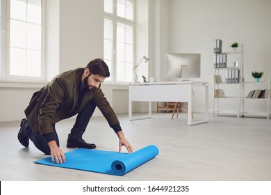 Businessman With Yoga Mat Is Standing In Office.