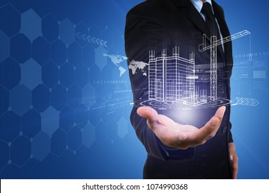 Businessman's Hand With Building Construction Design Reality Virtual Technology. Building Automation Digital Wireless Control Concept.