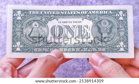 Businessman's hand holding American Dollar Banknotes, isolated on black background. Business Investment Economy Saving Loan Income Money and Finance concept. One Dollar, 1 USD. Prosperity concept.