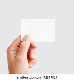 Businessman's Hand Holding Blank White Paper Business Card, Closeup Isolated On Square Gray Background