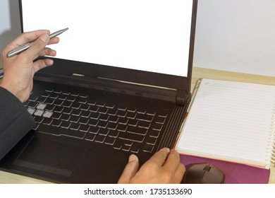 The businessman's hand holds a pen, pointing to the graph on the computer screen and there is a copy space. - Shutterstock ID 1735133690