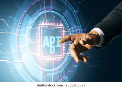 Businessman's hand interacting with a glowing futuristic virtual API interface, on a dark background. Concept of software development and technology