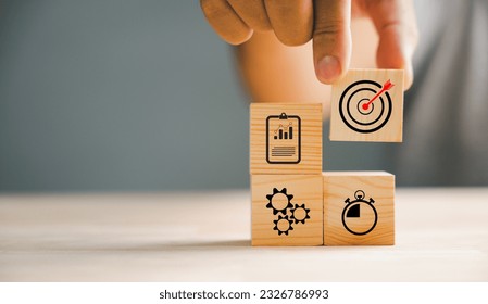 Businessman's hand meticulously arranging wood blocks, representing a business strategy and Action plan. Targeting the concept of goal achievement and success. - Shutterstock ID 2326786993