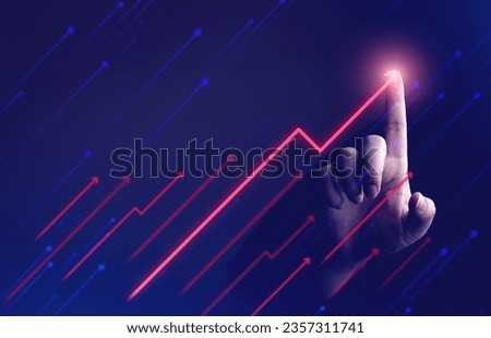 Businessman's hand showing rising arrow on dark background. concepts of business that express the development or increasing business opportunities and more profits