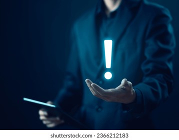 businessman's hand shows an icon exclamation mark. points attention. concept of signal alert, caution, or idea. information important in business and security