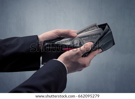 Millionaire business woman holding dollar bills - isolated over