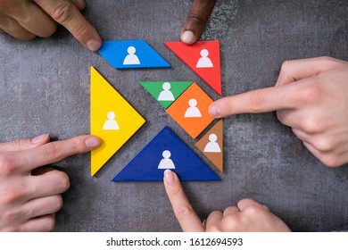 Businessman's Hands Building Tangram Square Block With Human Figures - Powered by Shutterstock