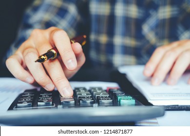 Businessman's hands with calculator at the office and Financial data Cost Economic