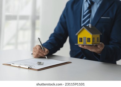 Businessmen, accountants, lawyers work in office investments, insurance, financial contracts, leasing, home deliveries for protection and custody. real estate concept property insurance. - Shutterstock ID 2311591101